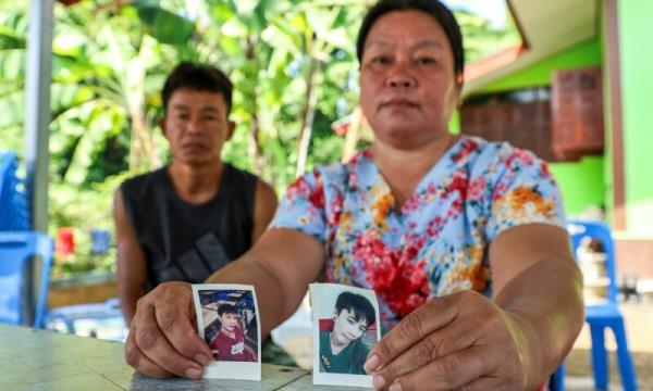 Thawatchai and Tho<em></em>ngkoon On-kaew, parents of Natthaporn, who was working in Israel, who has been abducted in the o<em></em>ngoing co<em></em>nflict between Israel and the Palestinian Islamist group Hamas, hold up his pictures during an interview with Reuters at their house in Nakhon Phanom, Thailand, October 10, 2023.—Reuters